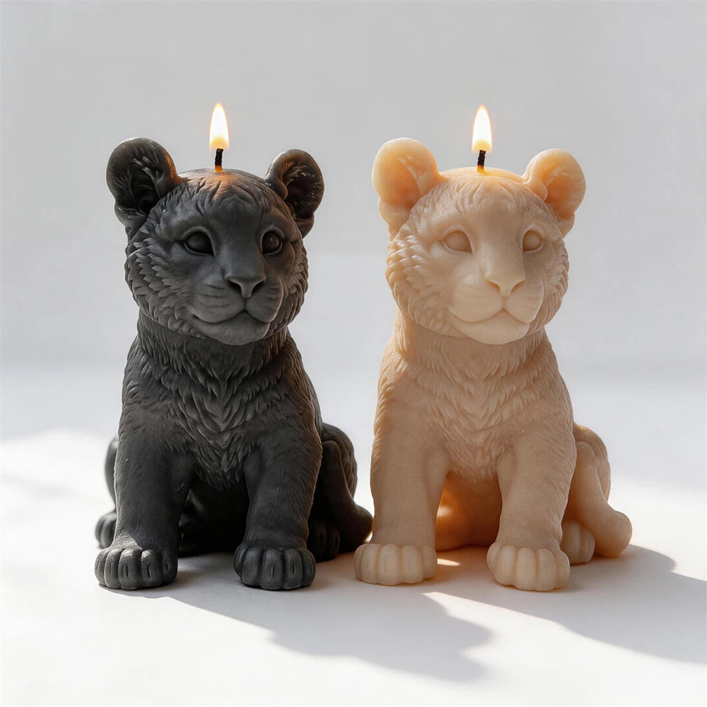 Front view of tiger cub candles with broad paws and detailed muzzles