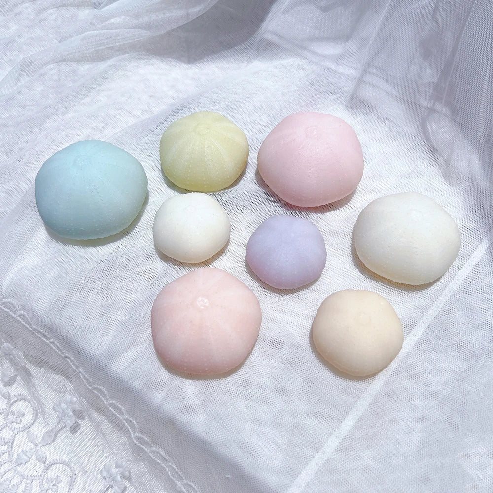 Overhead view of single sea-urchin domes in several colors