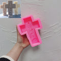Pink silicone cross mold with angel and nativity relief cavity