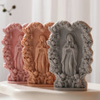 Floral Virgin Mary relief castings in three colors