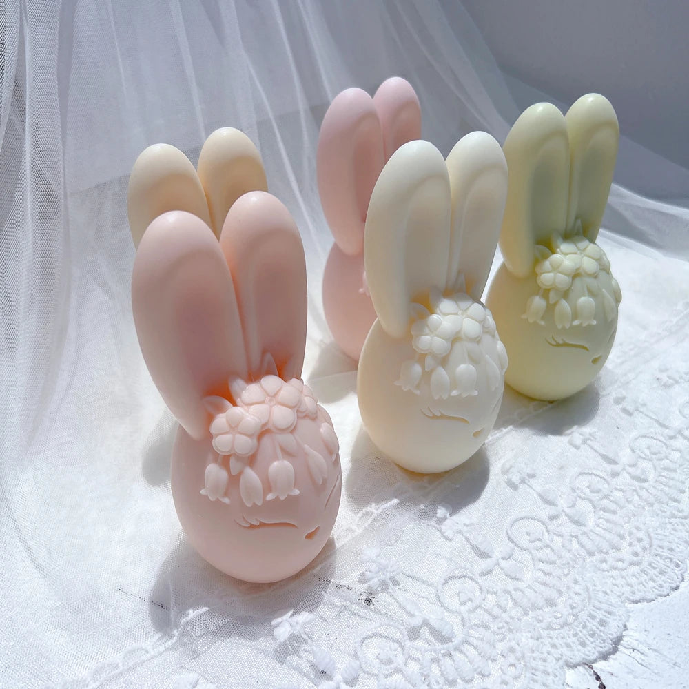 Pastel bunny egg candles arranged in staggered rows