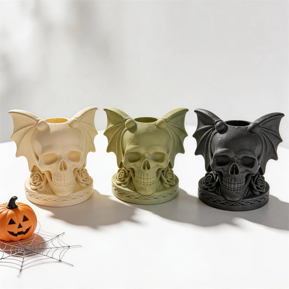 Three empty skull candleholders showing top sockets