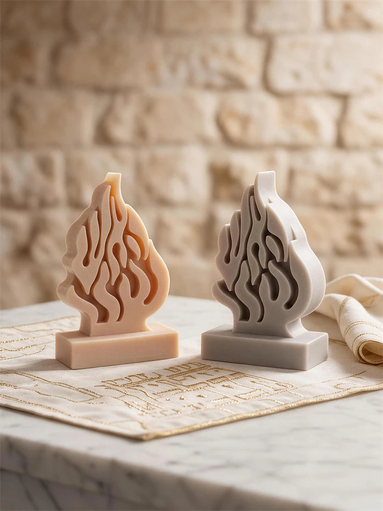 Cream and gray flame-shaped castings with curling relief on rectangular bases