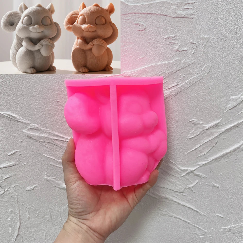 Pink silicone squirrel and acorn mold held in a hand