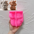 Pink silicone squirrel and acorn mold held in a hand