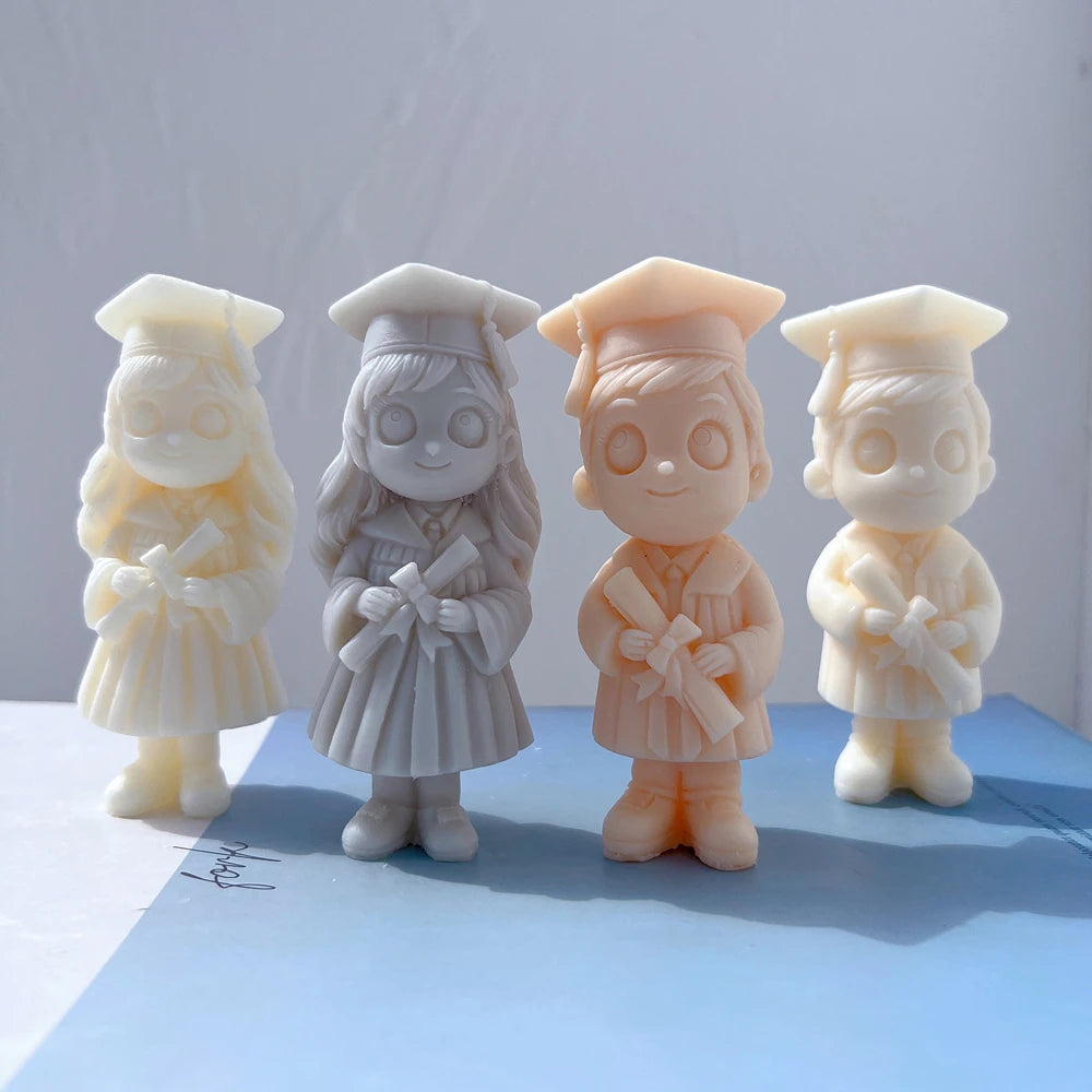 Four graduation figures with caps, gowns and diplomas