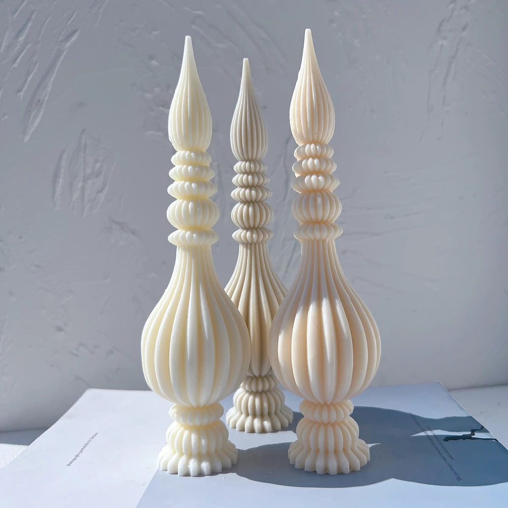 Front view of cream and gray sculptural finials with scalloped feet