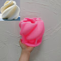 Pink silicone mold for broad spiral-ribbon candle form