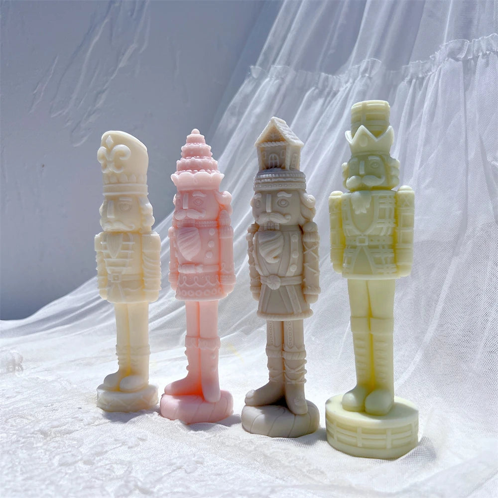 Four nutcracker soldier castings showing patterned hats and detailed uniforms