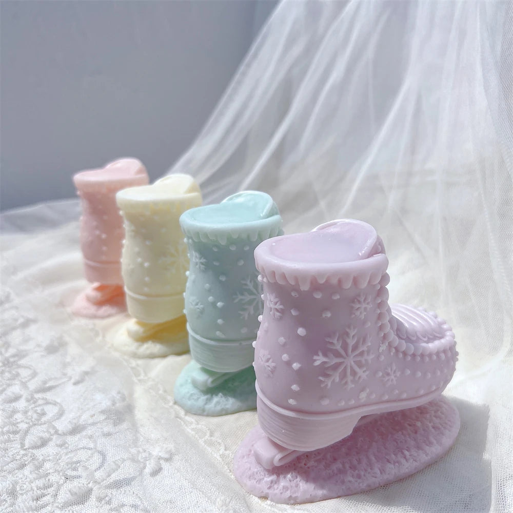 Side and back views of pastel boot-shaped candle sculptures