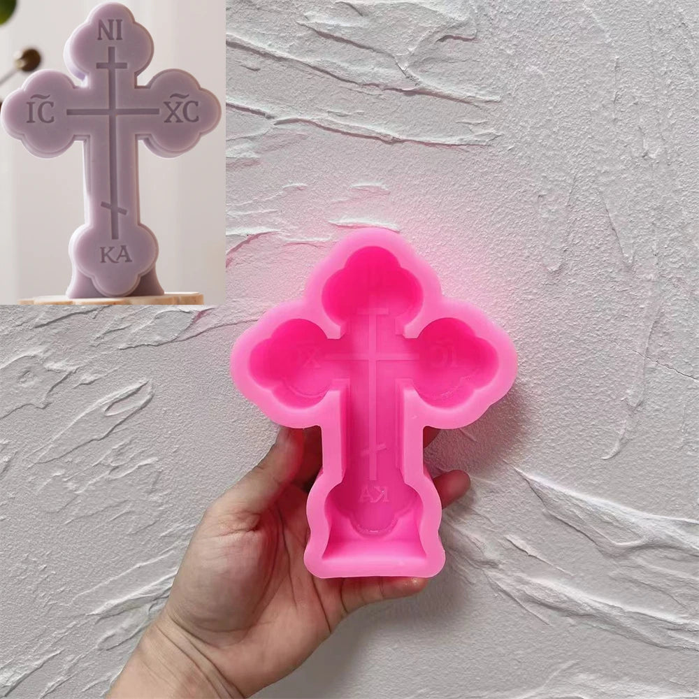 Pink Round Ends cross silicone mold beside a purple casting