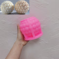 Pink silicone ball mold with a layered teardrop-scale cavity