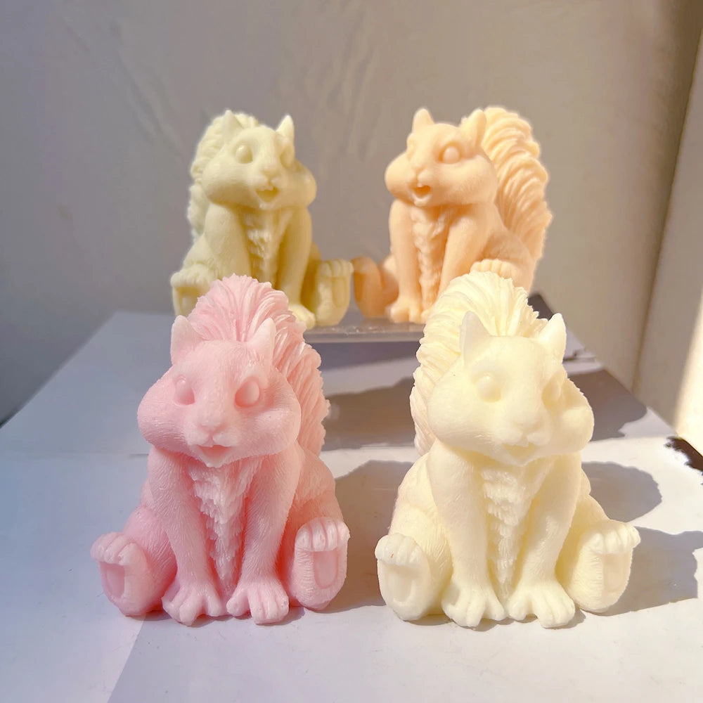 Sitting squirrel candle figures with sculpted tails and expressive faces