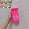 Pink silicone bunny egg mold held beside finished candle examples
