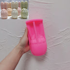 Pink silicone bunny egg mold held beside finished candle examples