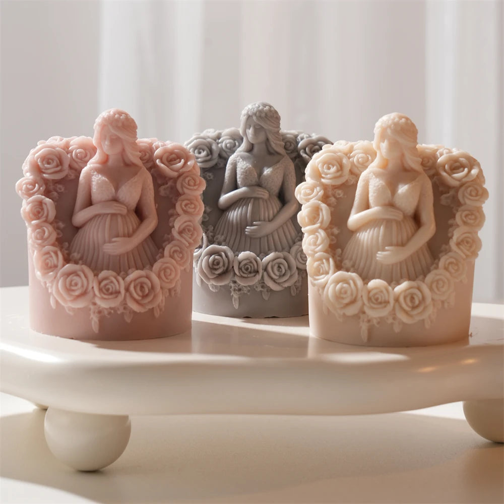 Rose-framed pregnancy figure candles on a display tray