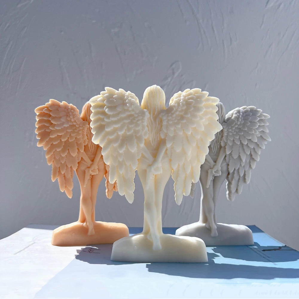 Ivory winged figure with layered feathers and slender legs