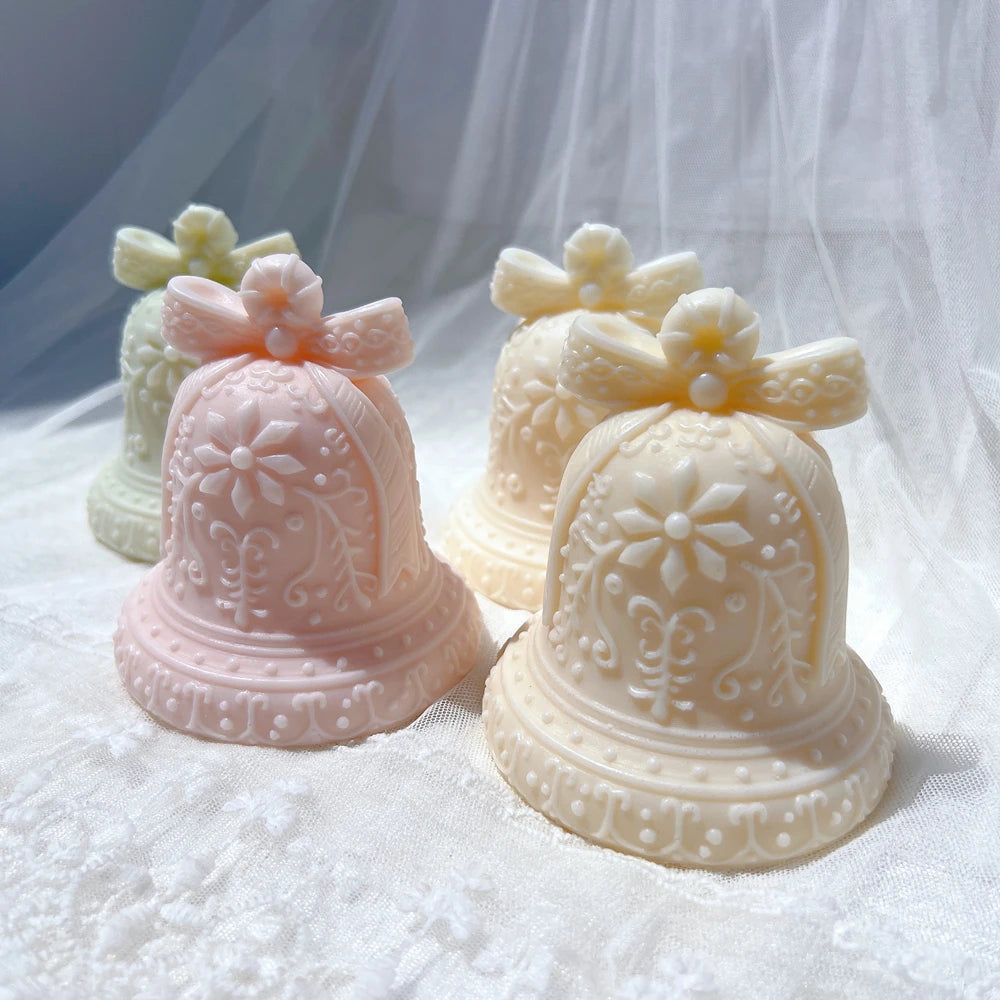 Pastel decorative gingerbread bell candles on a soft backdrop