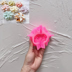 Pink silicone mold for layered poinsettia flower held in a hand