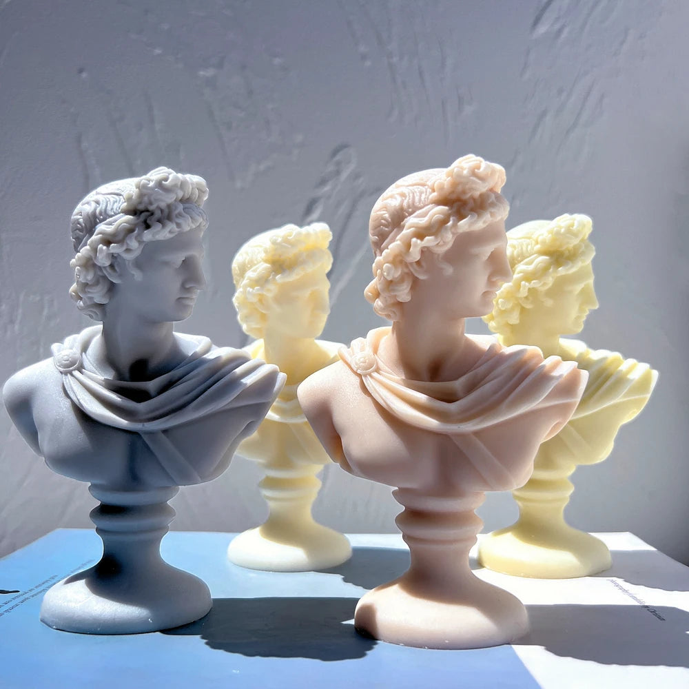Three-quarter profiles of classical bust candles on pedestal bases
