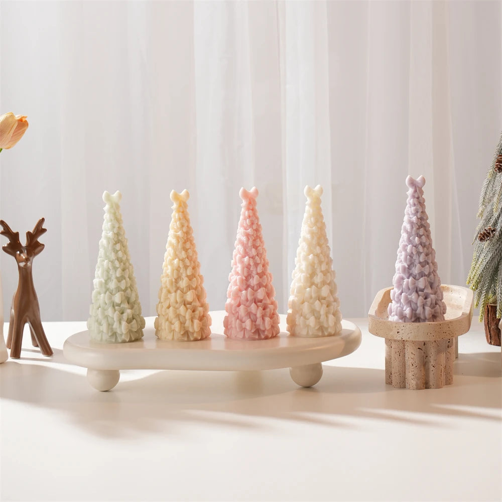 Slender Christmas tree castings covered in small bows