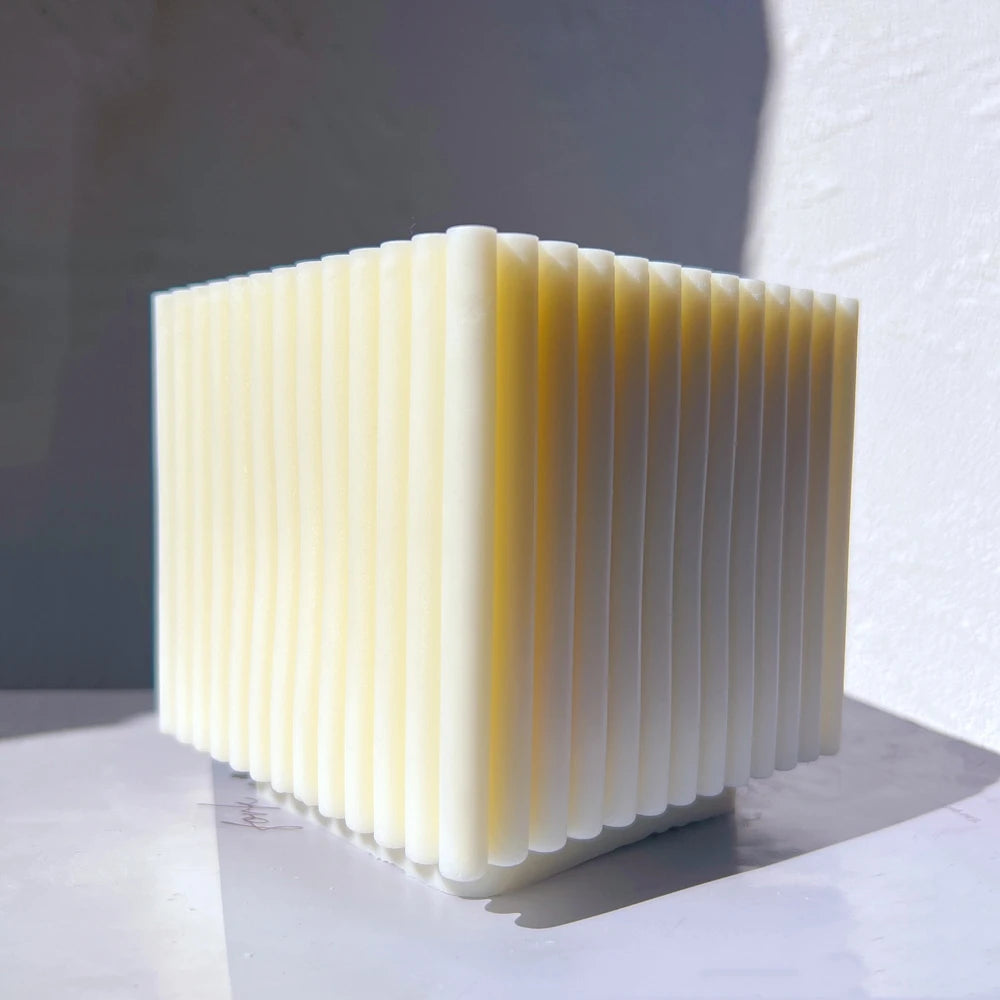 Square block candle with fine vertical side ribs