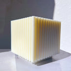Square block candle with fine vertical side ribs