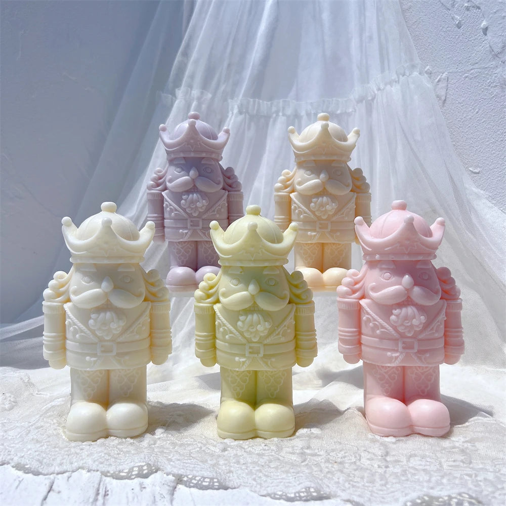 Five crowned nutcracker candle figures in pastel colors