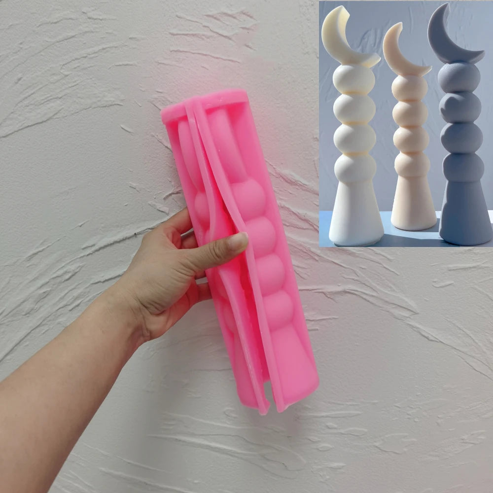 Pink silicone Three Ball Crescent sculpture mold held open