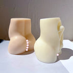 Rear view of two torso castings with curved waist and hip contours