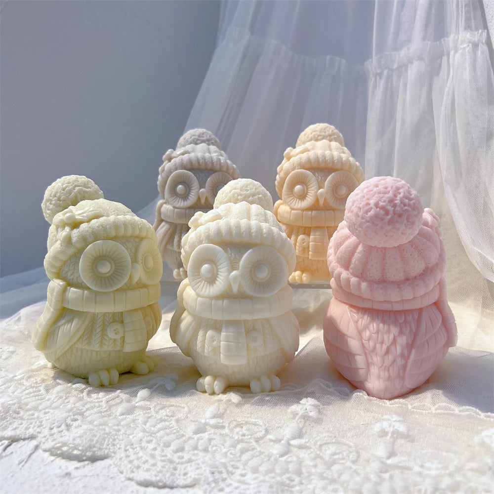 Front and rear views of winter owl candles with feather detail and pom-pom hats