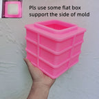 Pink silicone square block mold with instruction to use a flat support box
