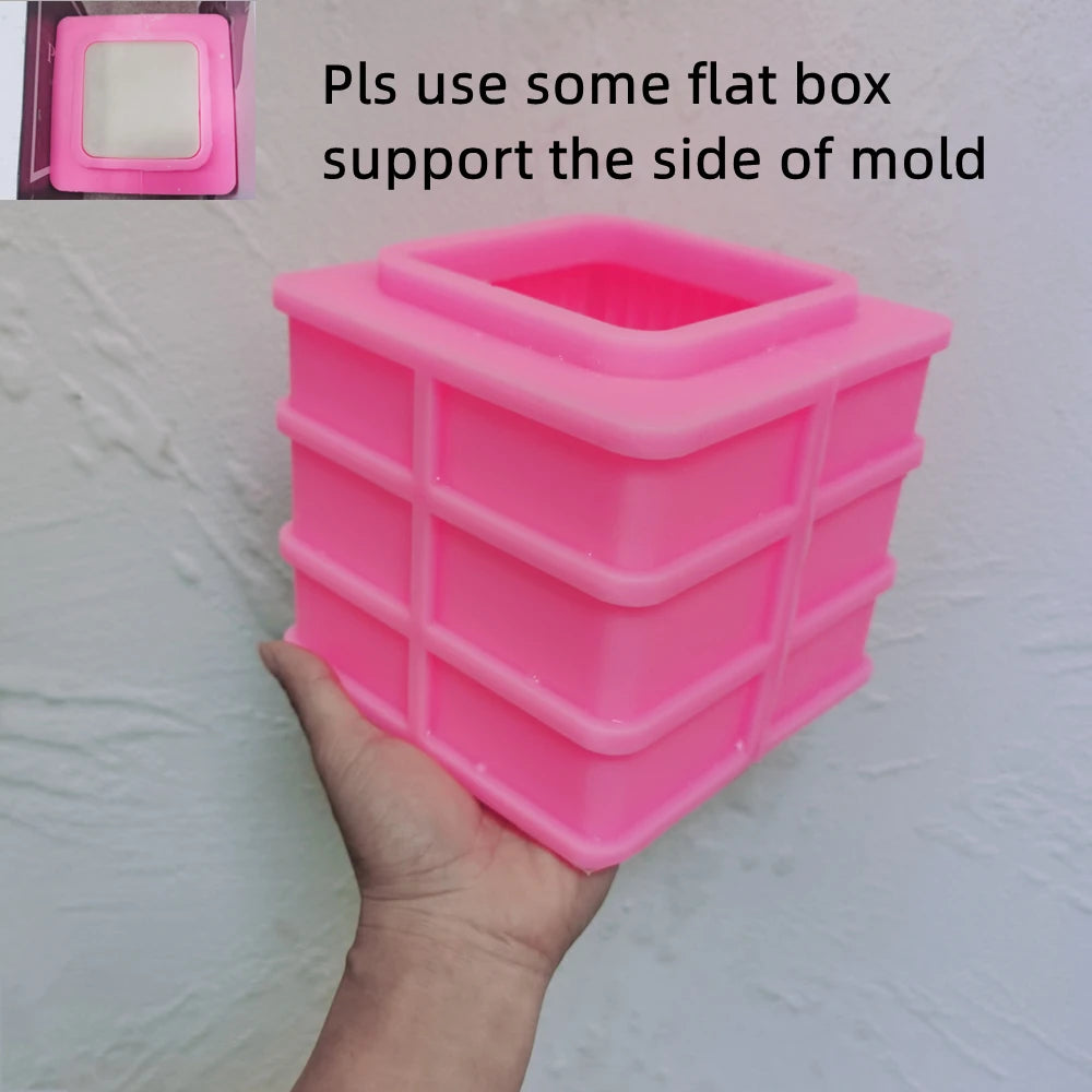 Pink silicone square block mold with instruction to use a flat support box