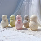 Russian Matryoshka candle figures from the back and front in pastel wax colors