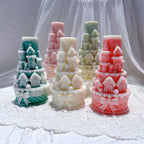 Five castle tower candles displaying bead-like trim and base bows