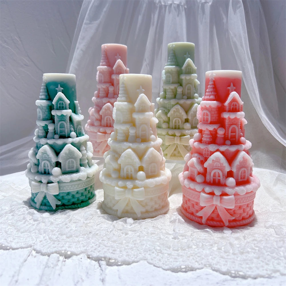 Five castle tower candles displaying bead-like trim and base bows