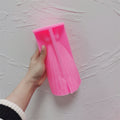 Pink silicone gown mold held to show its pleated skirt cavity