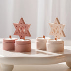 Pink and cream six-pointed star decorative castings above paired cups