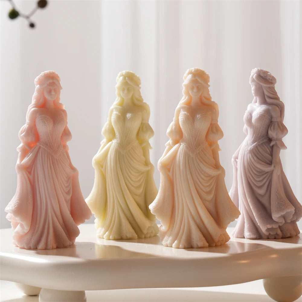 Graceful woman candle figures arranged on a curved white display