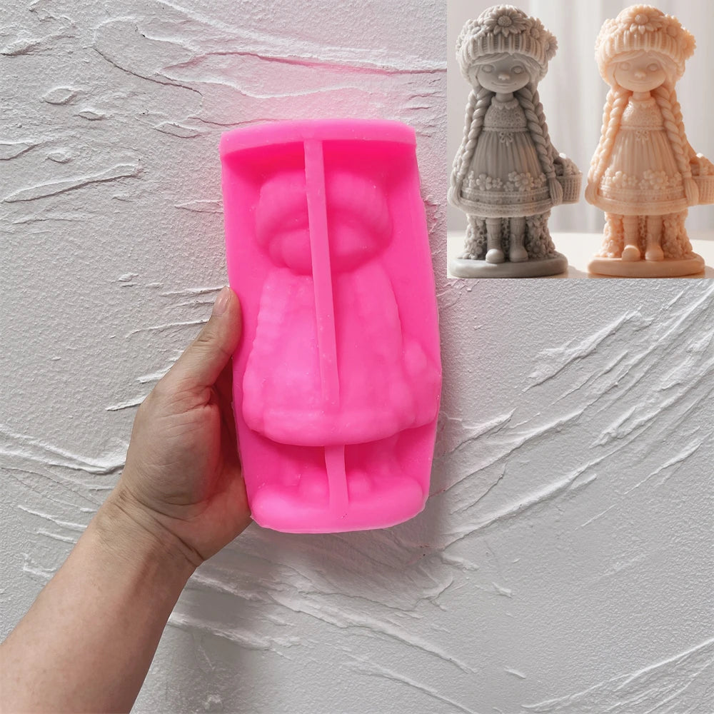Pink silicone mold for the braided flower girl figure held in a hand