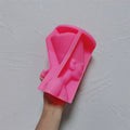 Pink Nefertiti-style bust silicone mold held in one hand