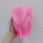 Pink silicone mold for horizontally ribbed folded-wave design
