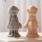 Front of gray flower girl beside the back of a peach casting with basket and dress folds