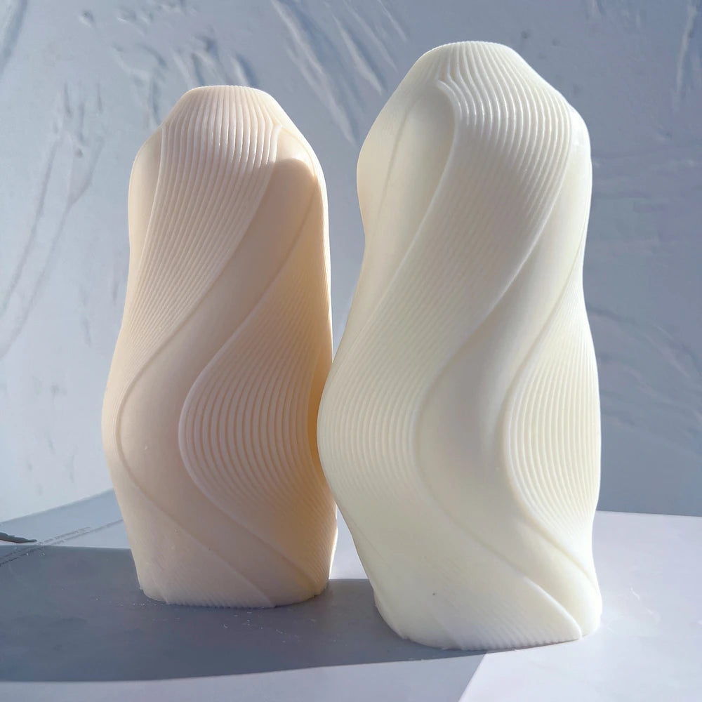 Cream wave castings showing asymmetric S-shaped profiles