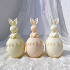 Carrot-holding bunnies above smooth eggs with scalloped top trim