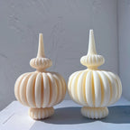 Two rounded ribbed pillar candles with narrow stems