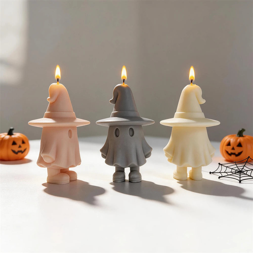 Peach gray and cream witch-hat ghosts beside Halloween props