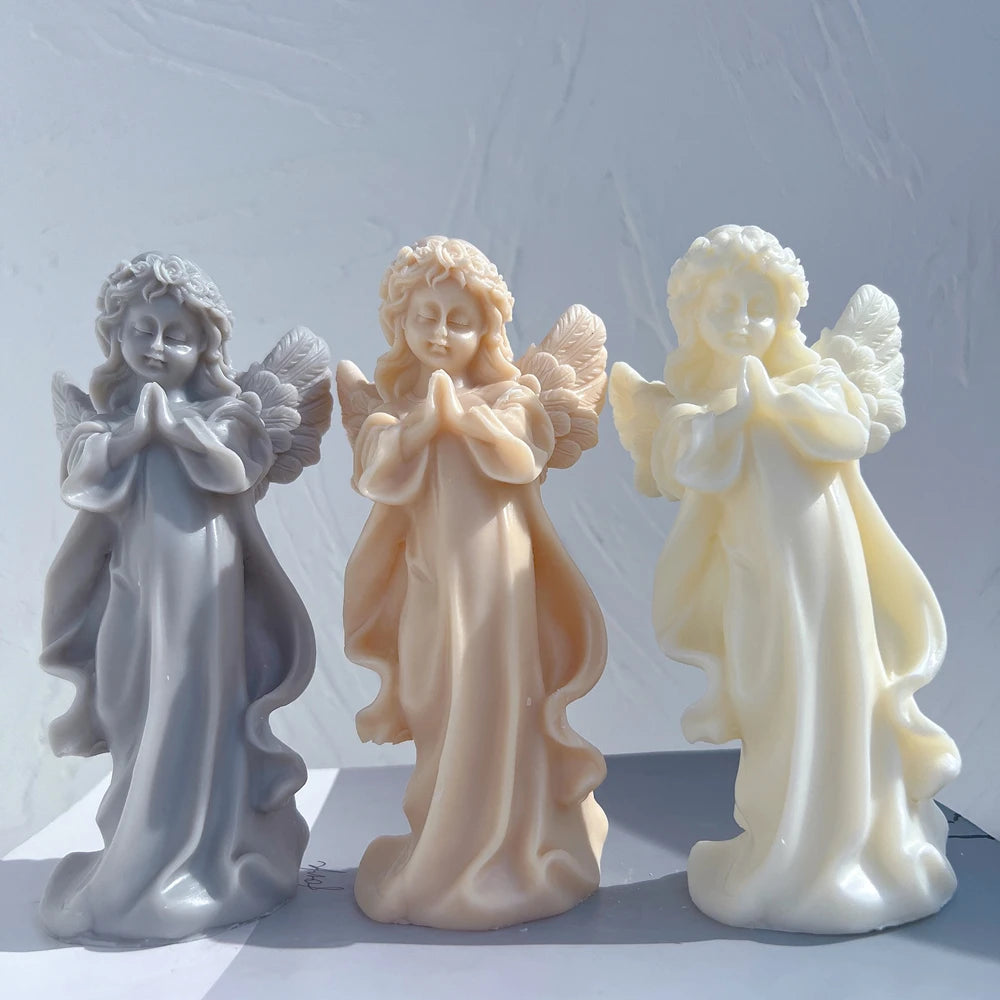 Three standing praying angel castings with joined hands and flowing robes