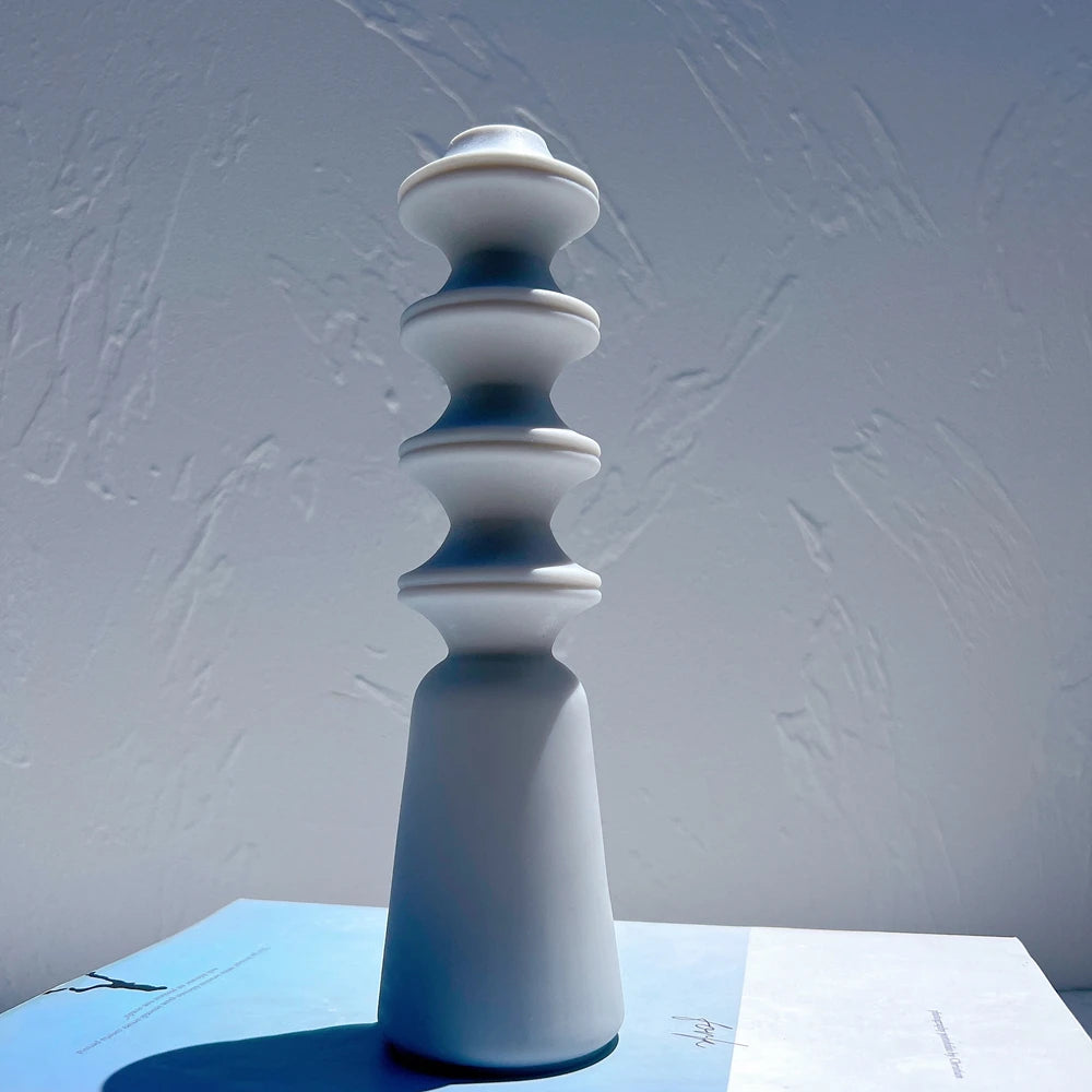 Single blue geometric pillar figure on a tapered base