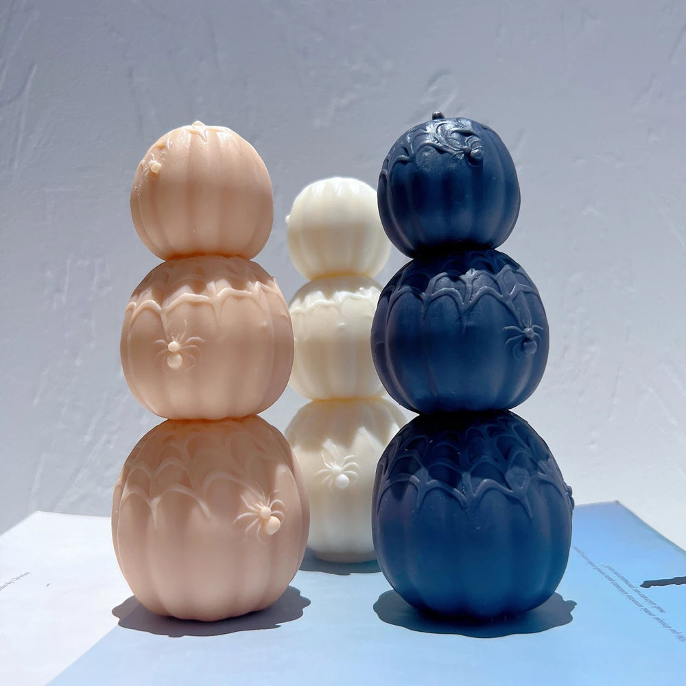 Angled pumpkin stacks showing web strands across their ribbed surfaces